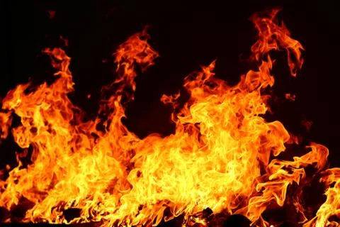 Fire burning in black background Stock Photos