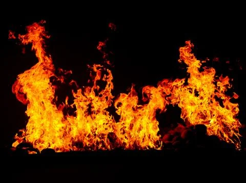 Fire burning in black background Stock Photos
