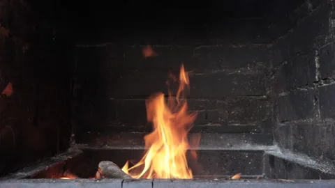 Fire burning in a brick fireplace Video stock 136468345
