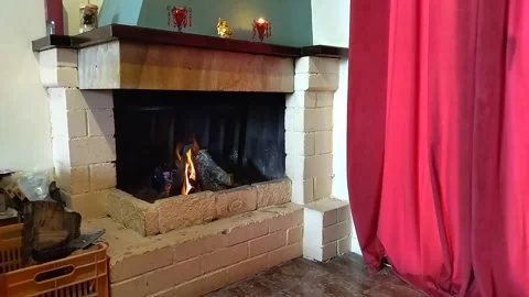 Fire burning brightly in an old stone fireplace Video stock 305030882