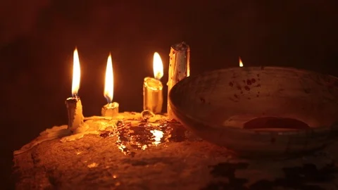 Fire is burning in the dark at night, there is a cup and candles Stock Footage 100741182