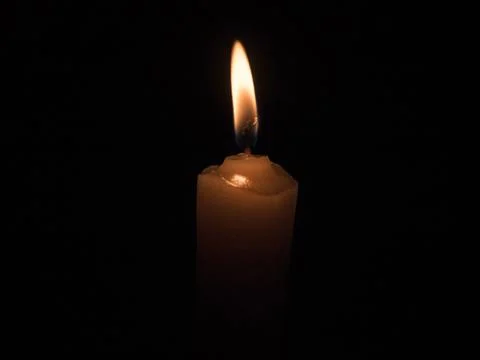 The fire burning in the darkness of a candle Foto stock