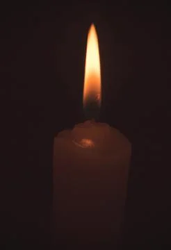 The fire burning in the darkness of a candle Fotos Stock
