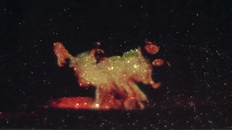 A fire burning in a fire bowl is projected onto a shiny, sparkling surface Stock Footage 313175003