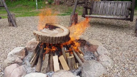 Fire burning in the fire pit at the camp site Stock Footage 212277246