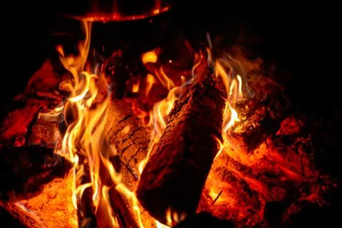 A fire burning in a fire pit at a campground Stock Photos