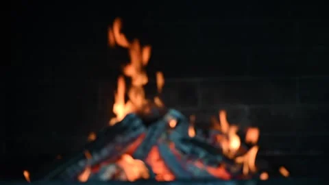 Fire burning in a fireplace. Defocus effect. Stock Footage 248415023