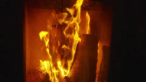 A fire is burning in a fireplace, with the flames reaching up to the ceiling Stock Footage 301517135
