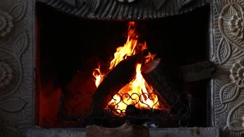 Fire is burning in the fireplace. Hearth. Warmth and home comfort. Flames of a c Stock Footage 152550247