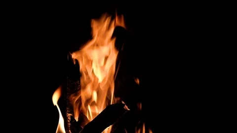 Fire burning in the fireplace. Slow motion video of fire flames over dark bac Video stock 92077413