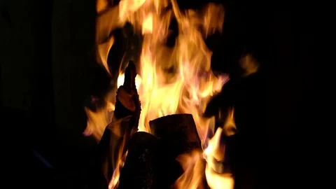 Fire burning in the fireplace. Video of fire flames over dark background Stock Footage 91930452