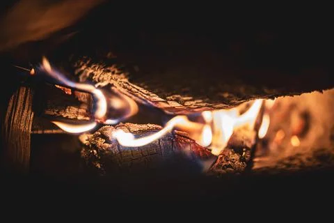Fire burning glowing in rustic wood burning cast iron stove, log burner for h Stock Photos