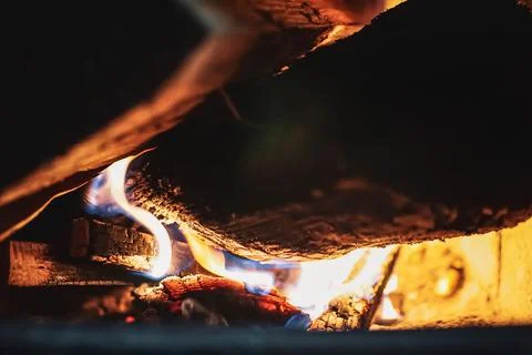 Fire burning glowing in rustic wood burning cast iron stove, log burner for h Stock Photos