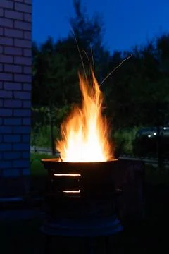The fire is burning in the grill. A bonfire burning at night Stock Photos
