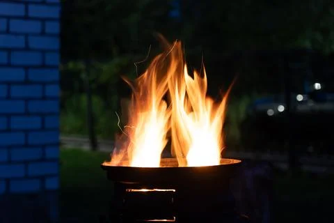 The fire is burning in the grill. A bonfire burning at night Stock Photos