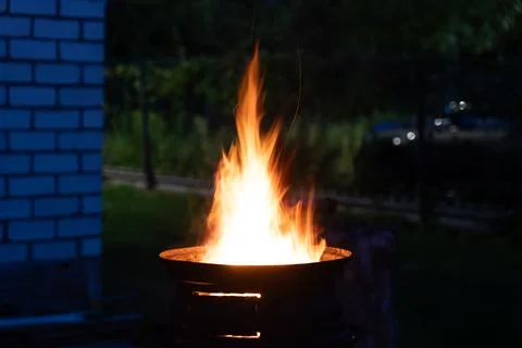 The fire is burning in the grill. A bonfire burning at night Stock Photos