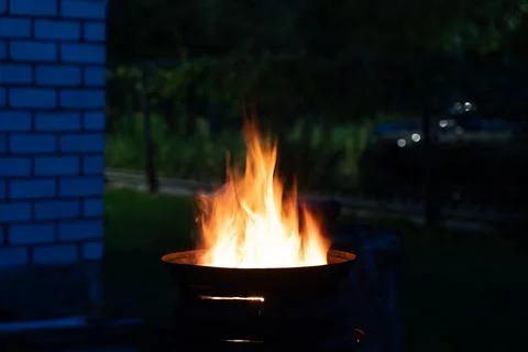 The fire is burning in the grill. A bonfire burning at night Stock Photos