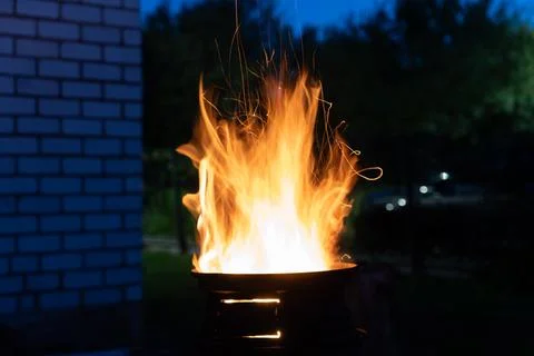 The fire is burning in the grill. A bonfire burning at night Stock Photos