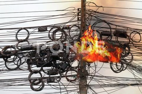 Fire is burning at High Voltage Cables power, Danger wire tangle cord Stock Photos