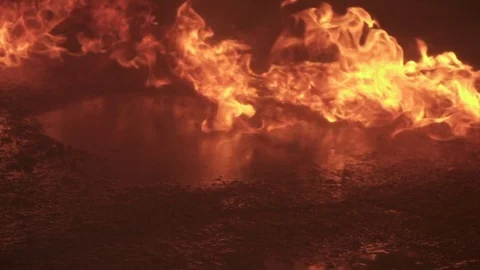 Fire burning in a line, reflected on water in slow motion 動画素材 76800947