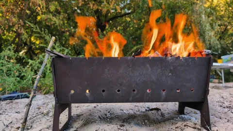 Fire Burning in a Metal Grill on the Beach, Preparing for a BBQ Video stock 291894982