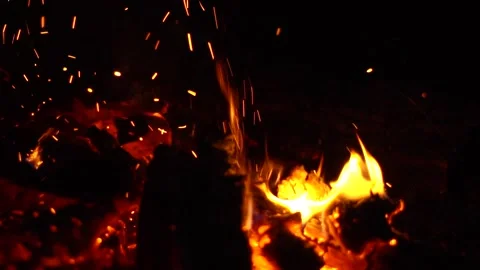 A fire is burning at night sparks fly Stock Footage 136023593