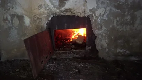 A fire is burning in an old stove in the wall. Vídeos de archivo 232720307