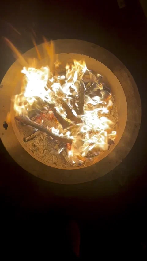 A fire burning in an outdoor fire pit in a suburban backyard Stock Footage 288382707