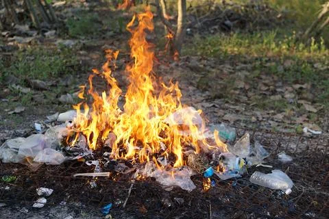 Fire burning pile of garbage. Stock Photos