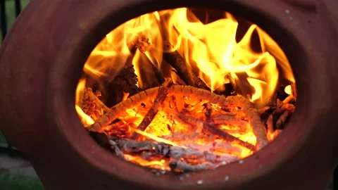 Fire Burning in red clay Chiminea Fireplace Stock Footage 130968501