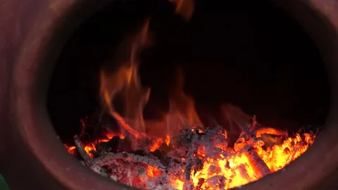Fire Burning in red clay Chiminea Fireplace Stock Footage 130978190