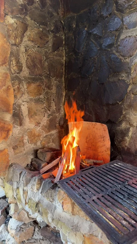 Fire Burning in Rustic Outdoor Stone Grill for Cooking Video stock 333571916