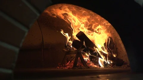 Fire burning in slow motion inside pizzeria brick oven  Stock Footage 86911963