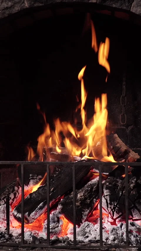 The fire is burning in the stone fireplace. Video stock 325768368