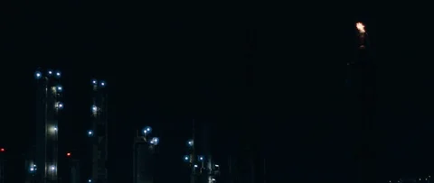 Fire burning at the top of chimney tower at the power plant at night,slow motion Stock Footage 121490450