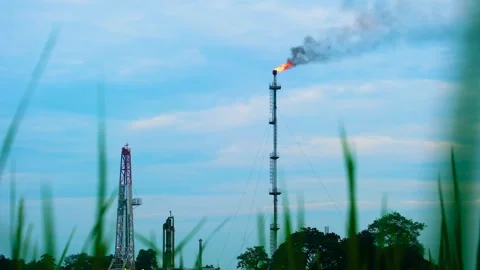 Fire burning on top of gas flare stack chimney on petroleum refinery with Video stock 266894156