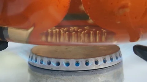 Fire burning under saucepan with boiling eggs Stock Footage 97739387