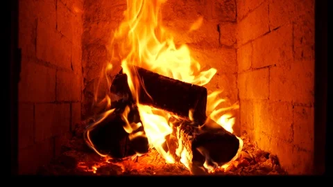 Fire burning with vivid flames in stove - close up, slight slow motion Видео 105295232