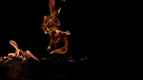 Fire burning on water in slow motion against black background Stock Footage 81231245
