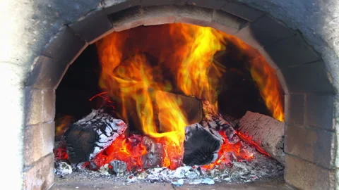 Fire burning in wood oven with flames glowing coals at cooking in evening hours Stock Footage 337006718