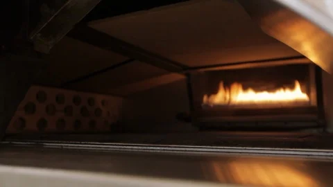 Fire burns in the back of an oven Stock Footage 90886445