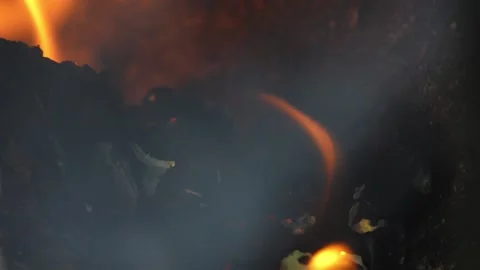 Fire burns beautifully in small metal fireplace. Stock Footage 195599092