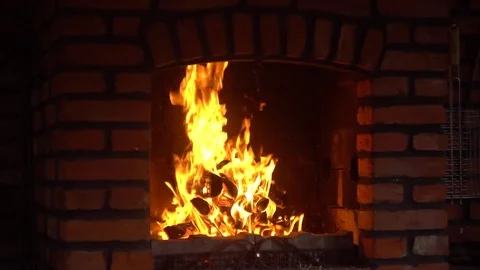The fire burns in the brick fireplace 4K Video stock 79464149