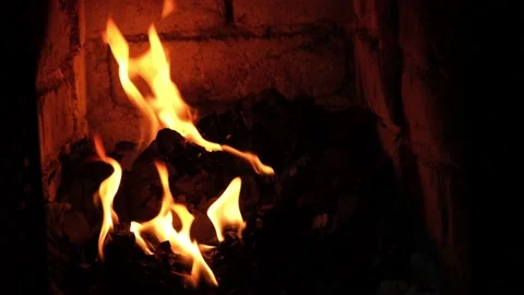 A fire burns in a brick fireplace, creating a warm and cozy atmosphere Stock Footage 201145780