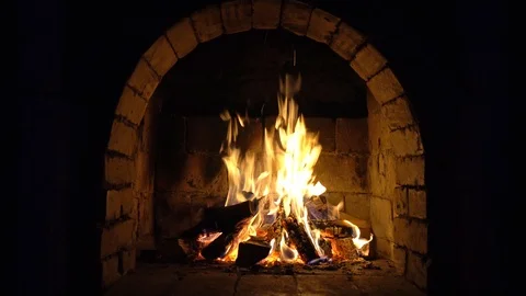 A fire burns in a brick fireplace, keep warm Stock Footage 102204394