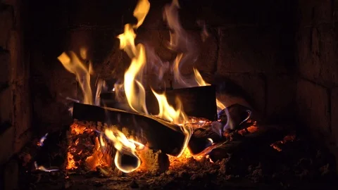 A fire burns in a brick fireplace, keep warm Stock Footage 102204890