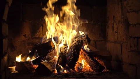 A fire burns in a brick fireplace, keep warm Stock Footage 103170987