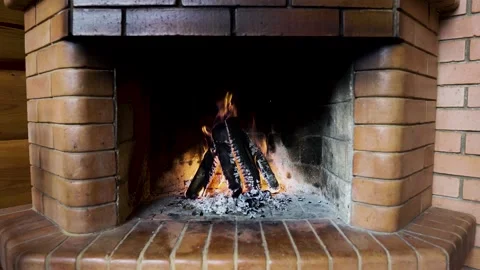 Fire burns in a brick fireplace. Video 1 Stock Footage 131455485
