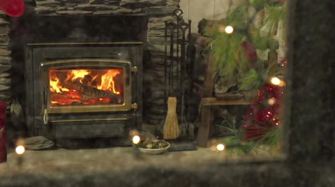 Fire burns brightly indoors - shot through window as snow falls Stock Footage 42139104