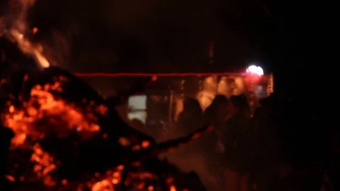 Fire burns by a crowd of people Stock Footage 122802344
